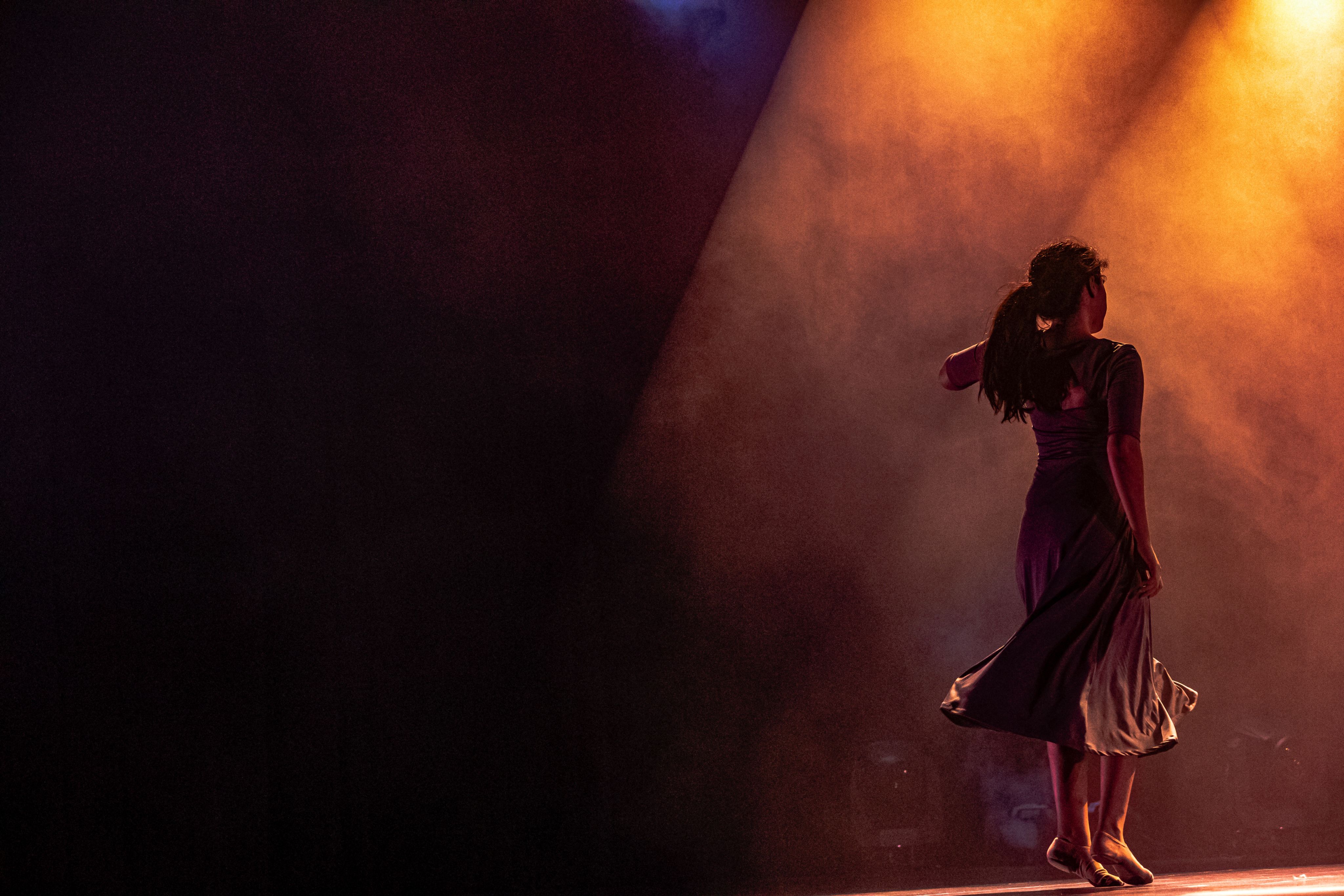 woman in dress on stage