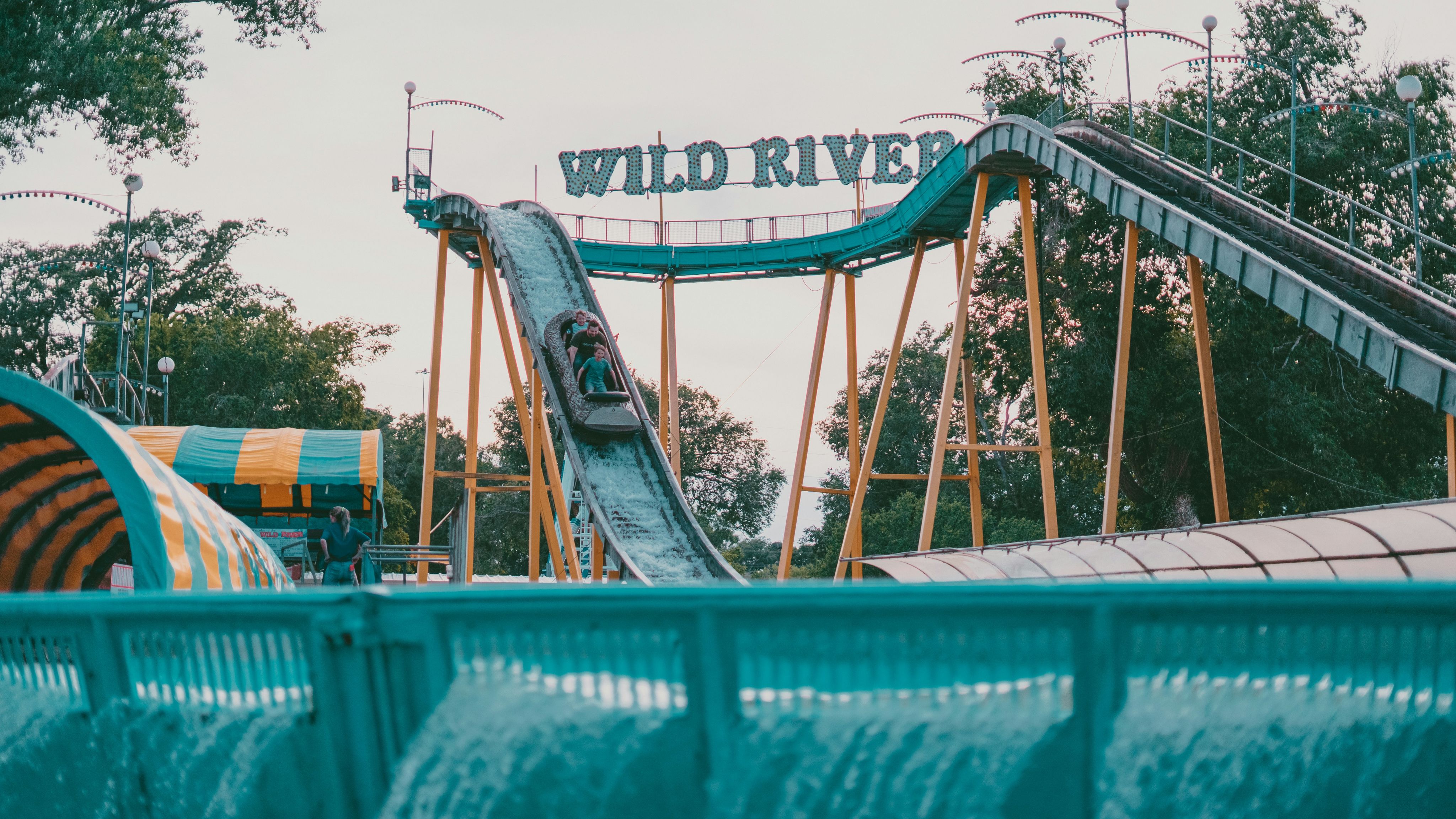 a roller coaster going down a hill in a theme park