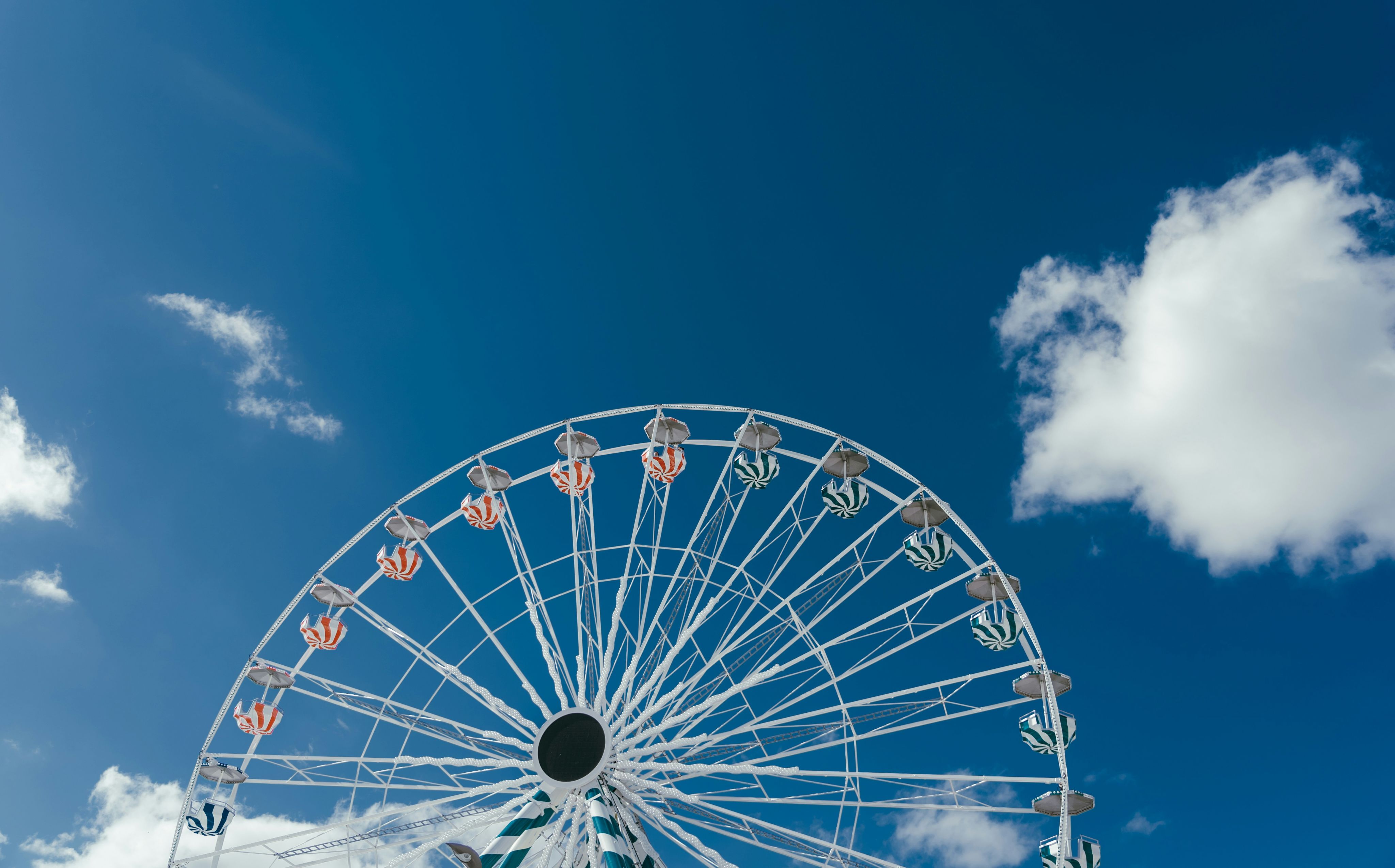 a large ferris wheel sitting under a blue sky
