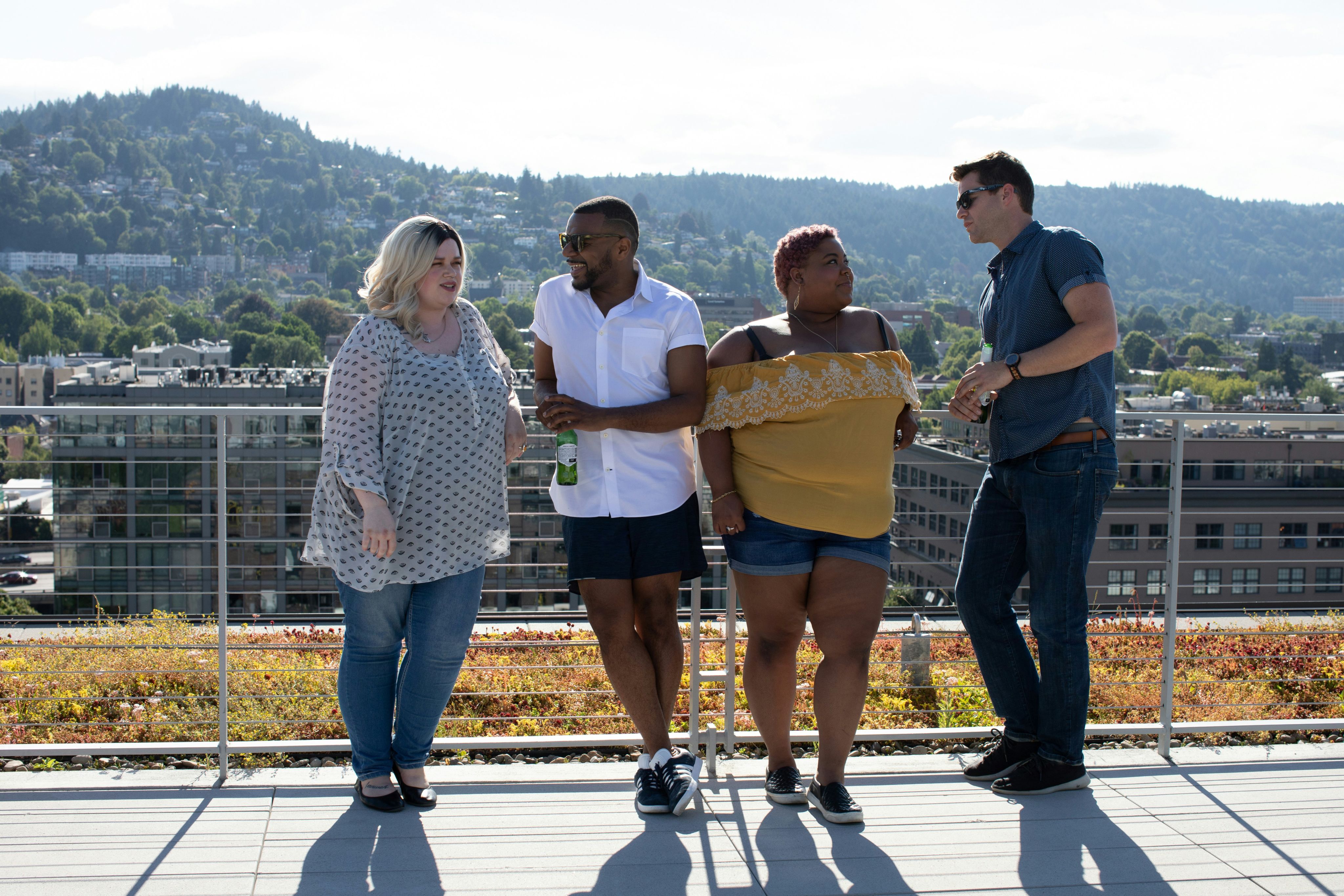 four people leaning on railings