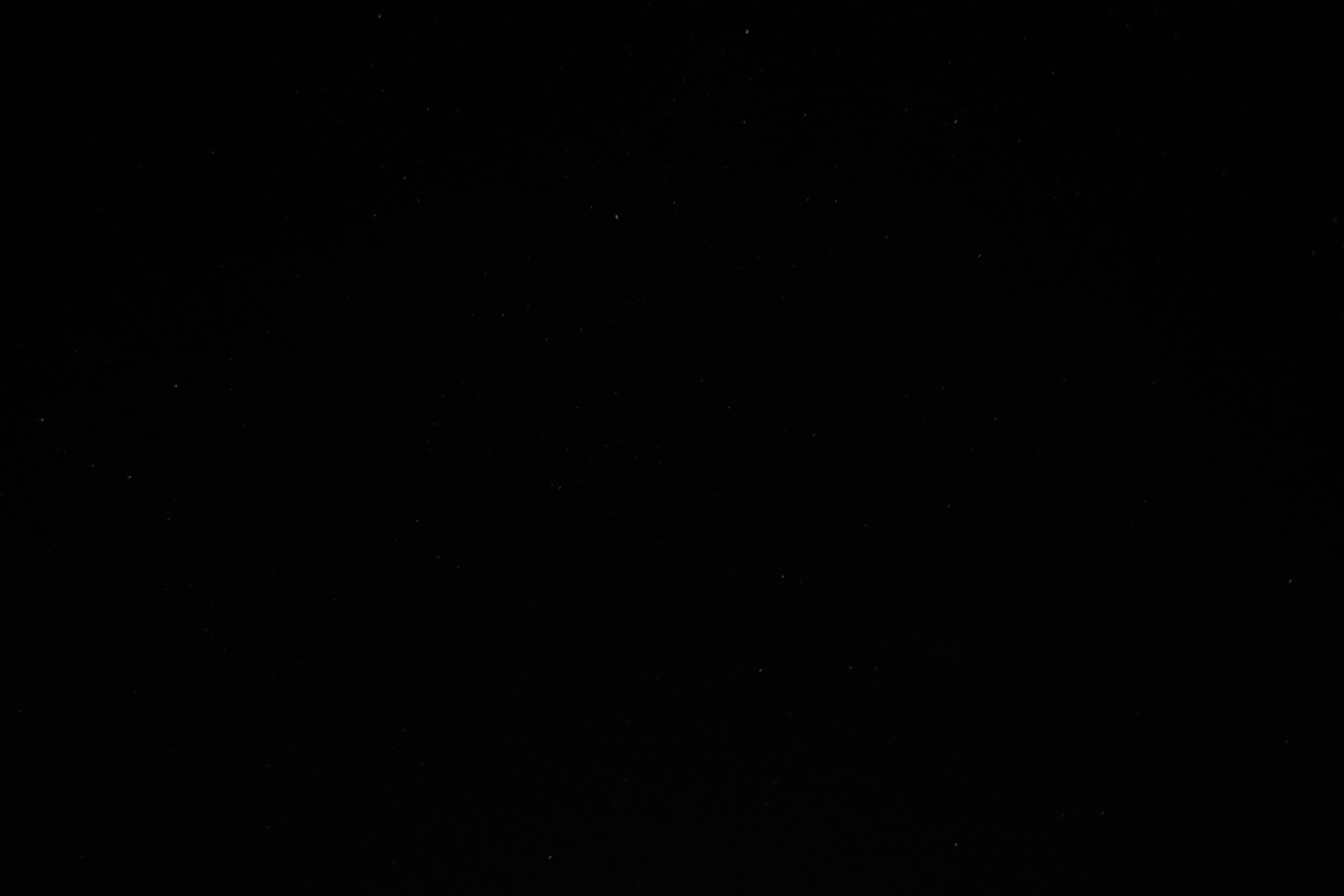 a night sky with stars and a few clouds