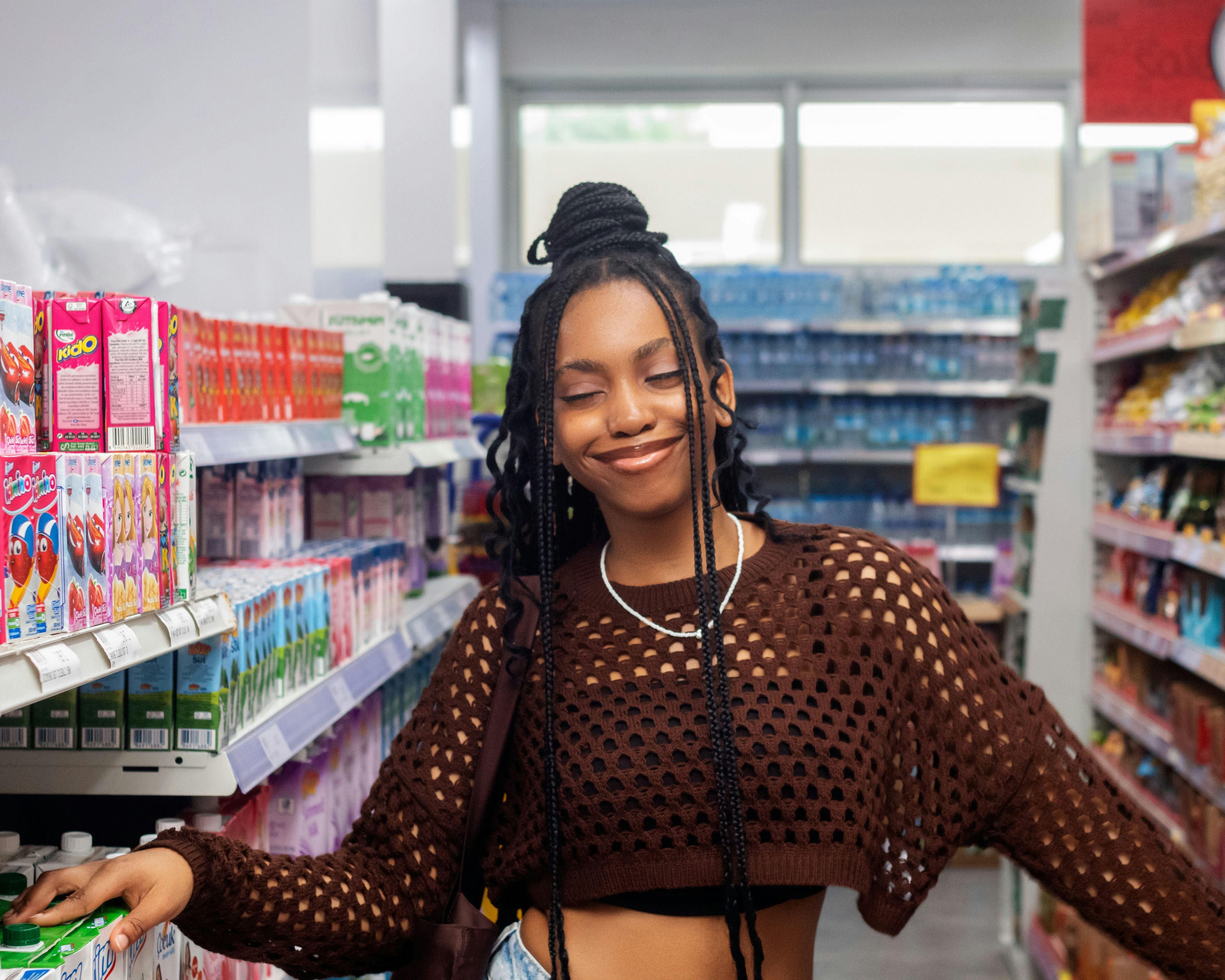 Woman pushing a cart while shopping in a grocery store.