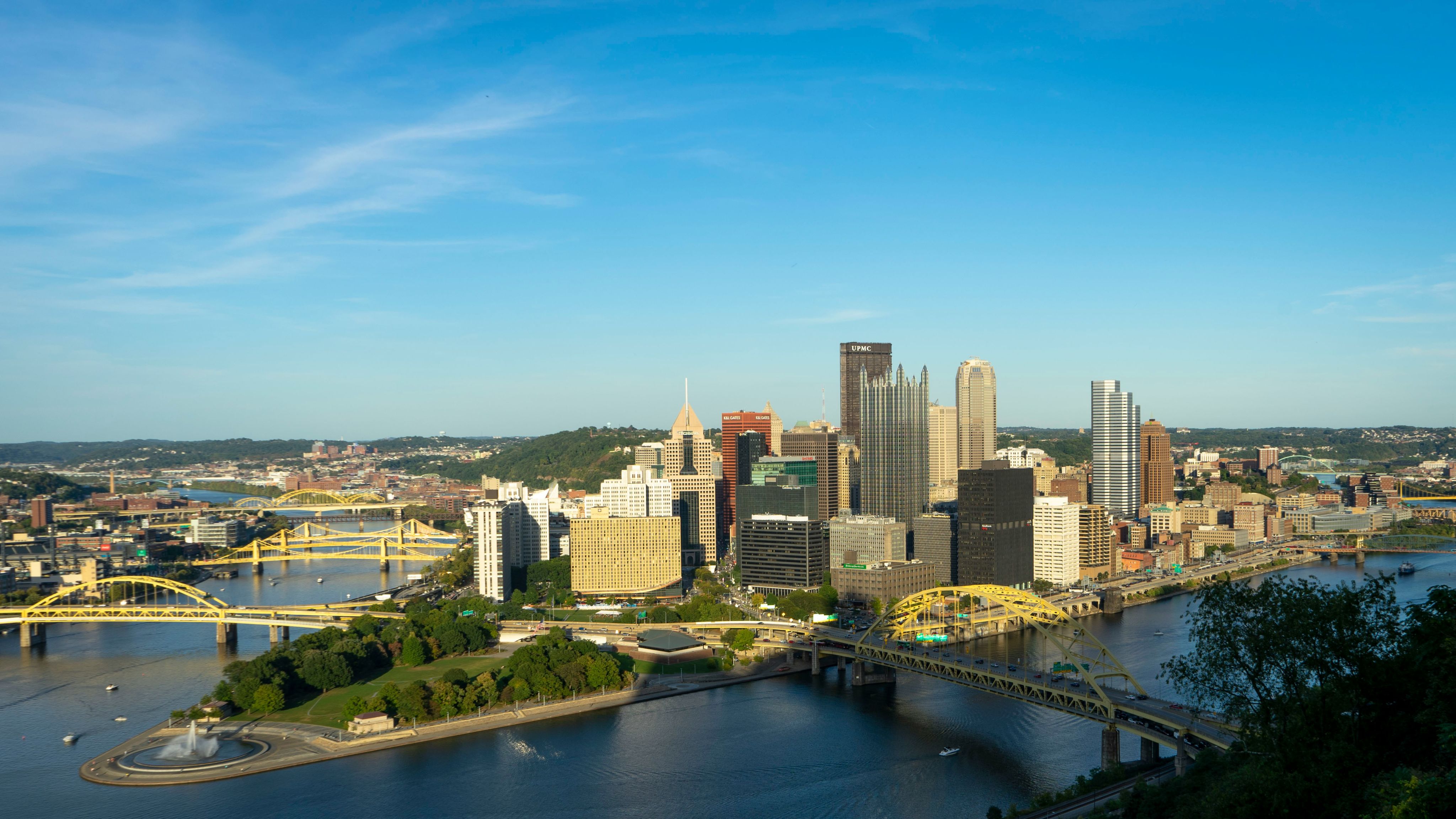 city with high-rise building viewing blue sea under blue and white skies during daytime