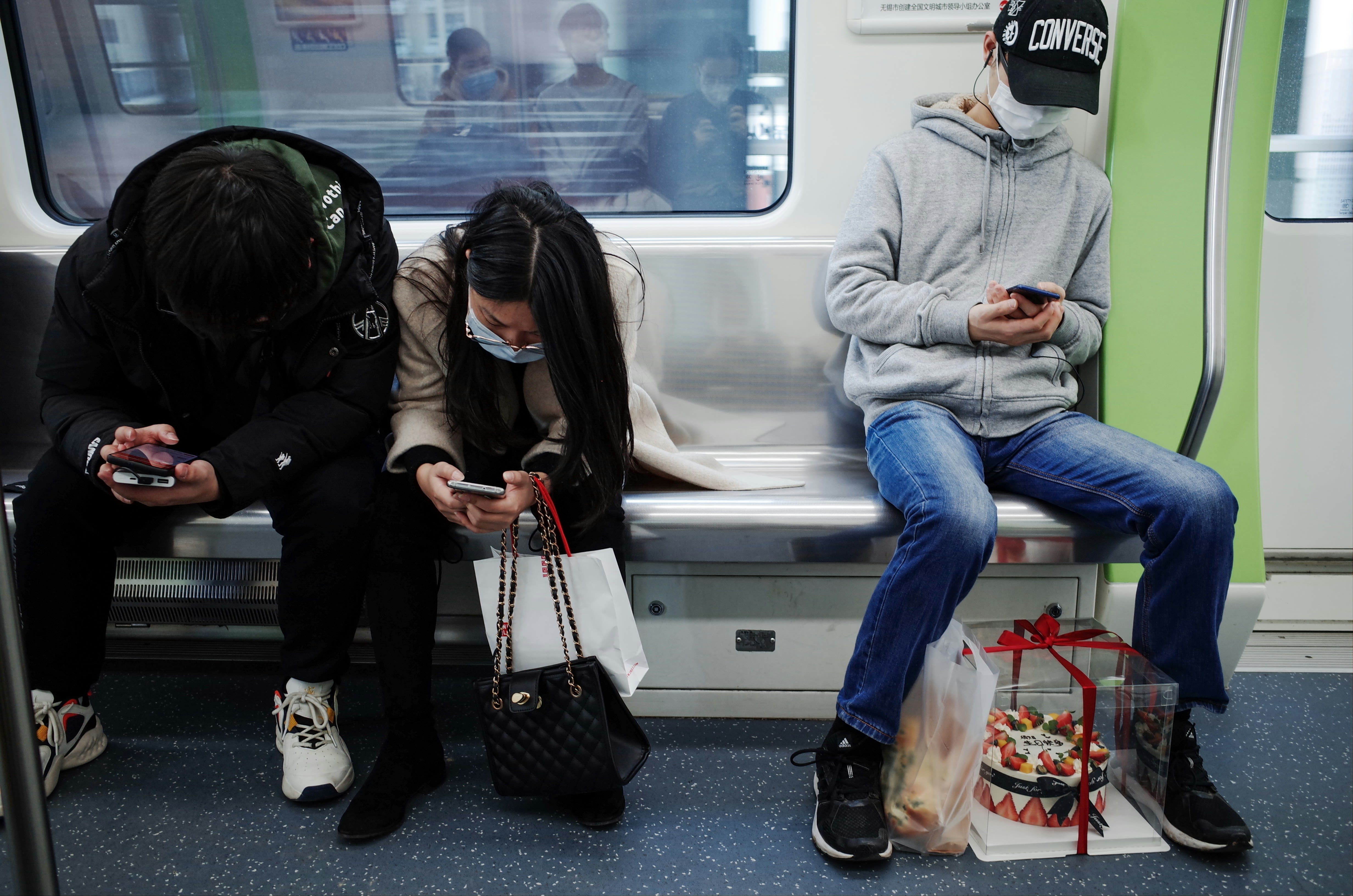 woman in gray sweater sitting beside woman in black leather jacket