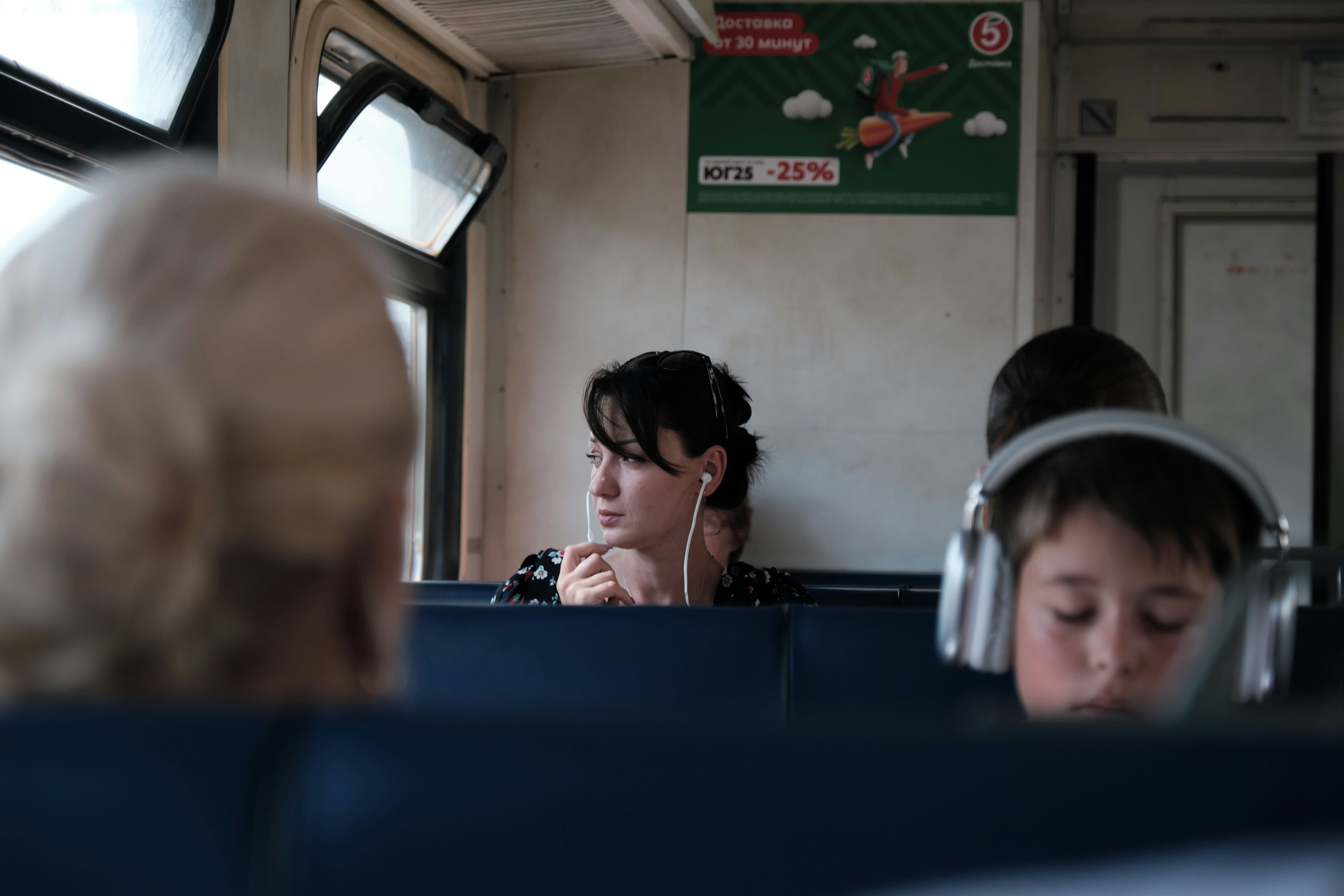 A group of people sitting on a bus next to each other