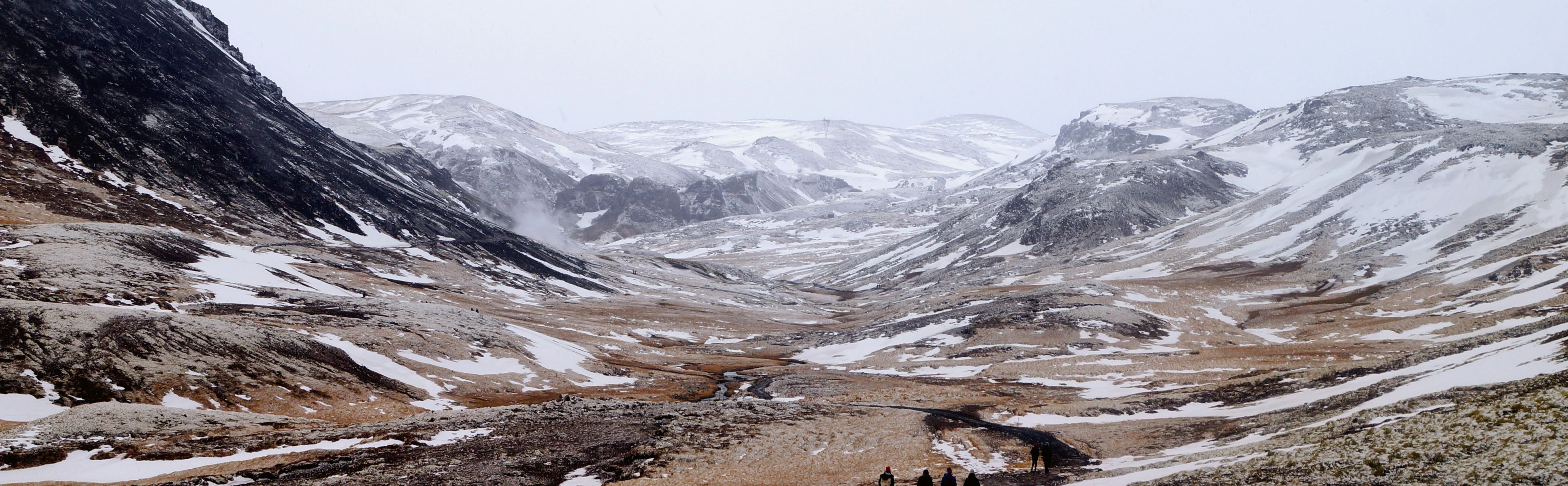 a group of people walking on a rocky terrain
