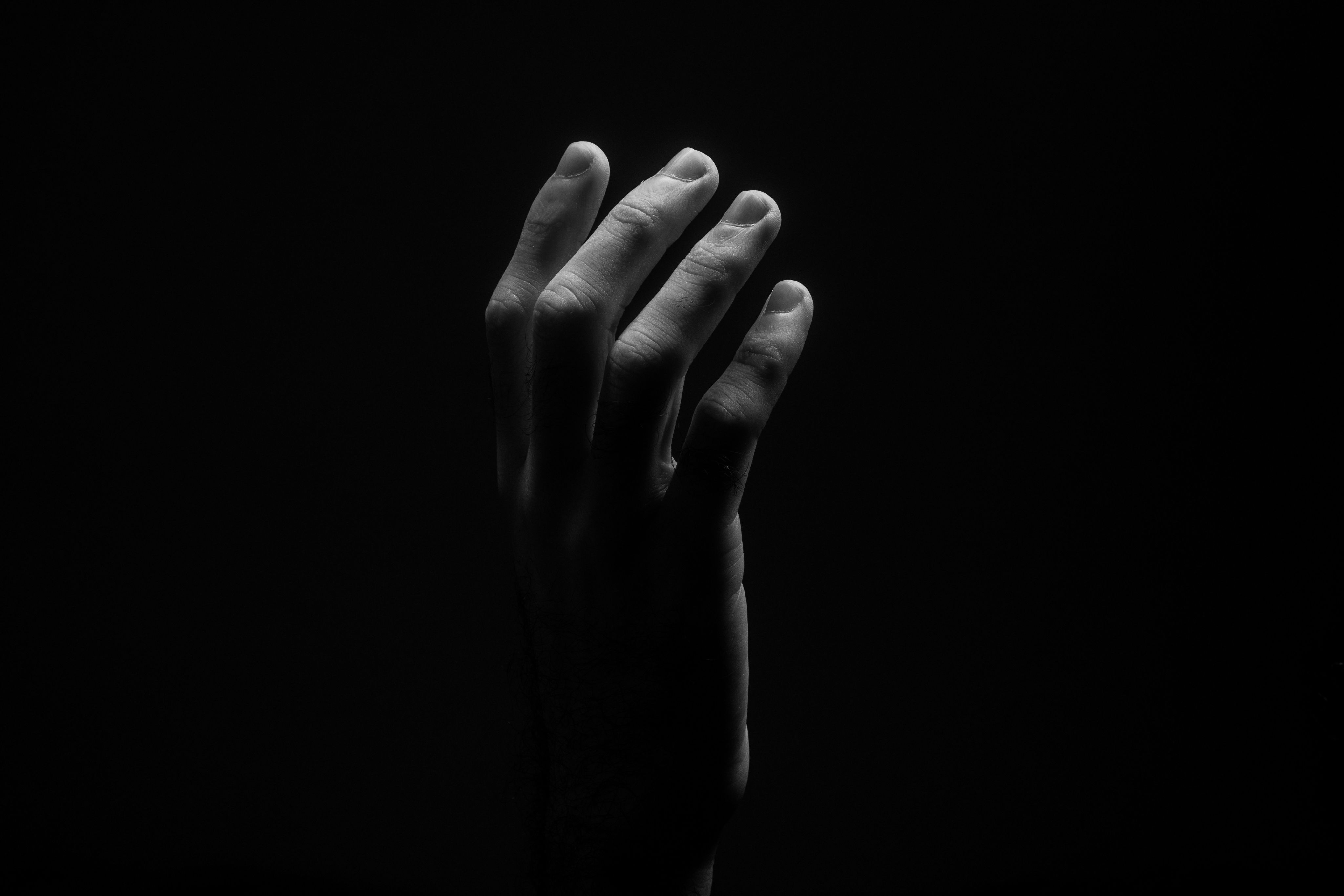 grayscale photo of persons hand
