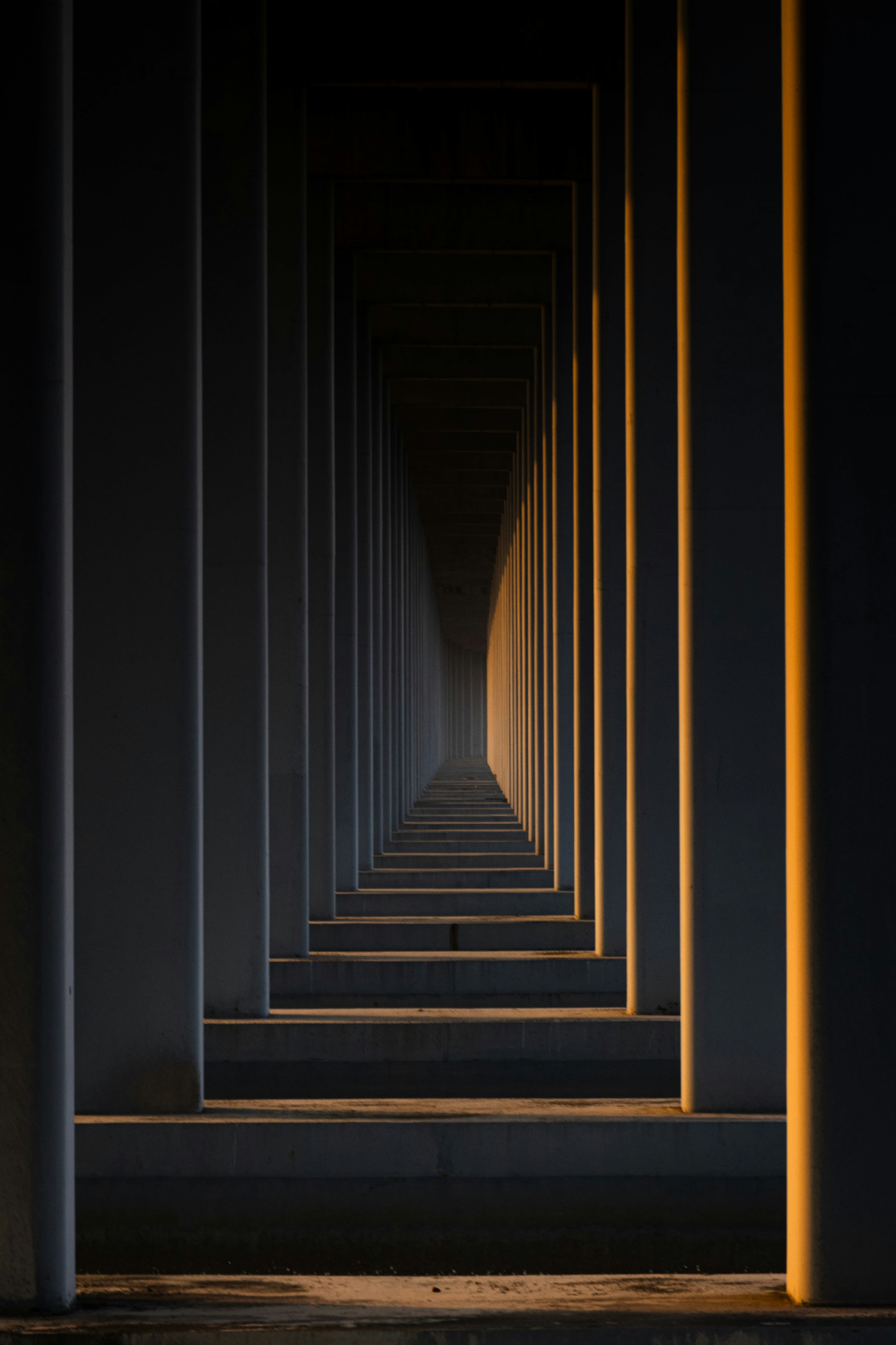 A long hallway with a light at the end of it